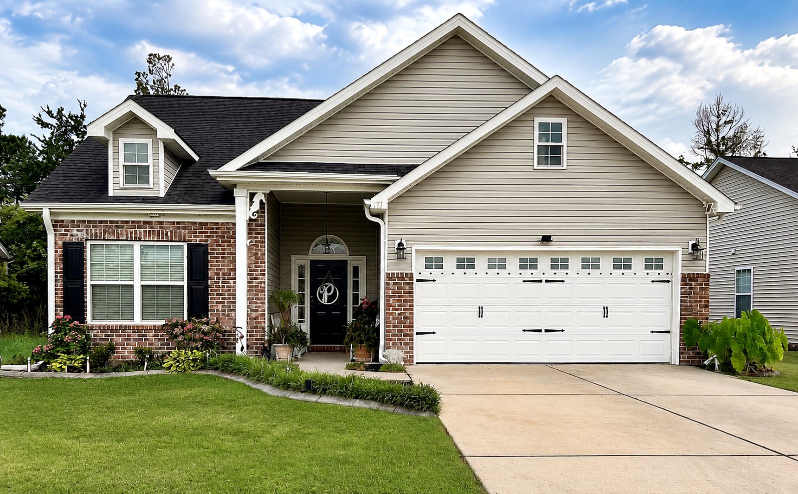 117 Blue Stem Dr — front exterior, brick and gray siding, two-car garage